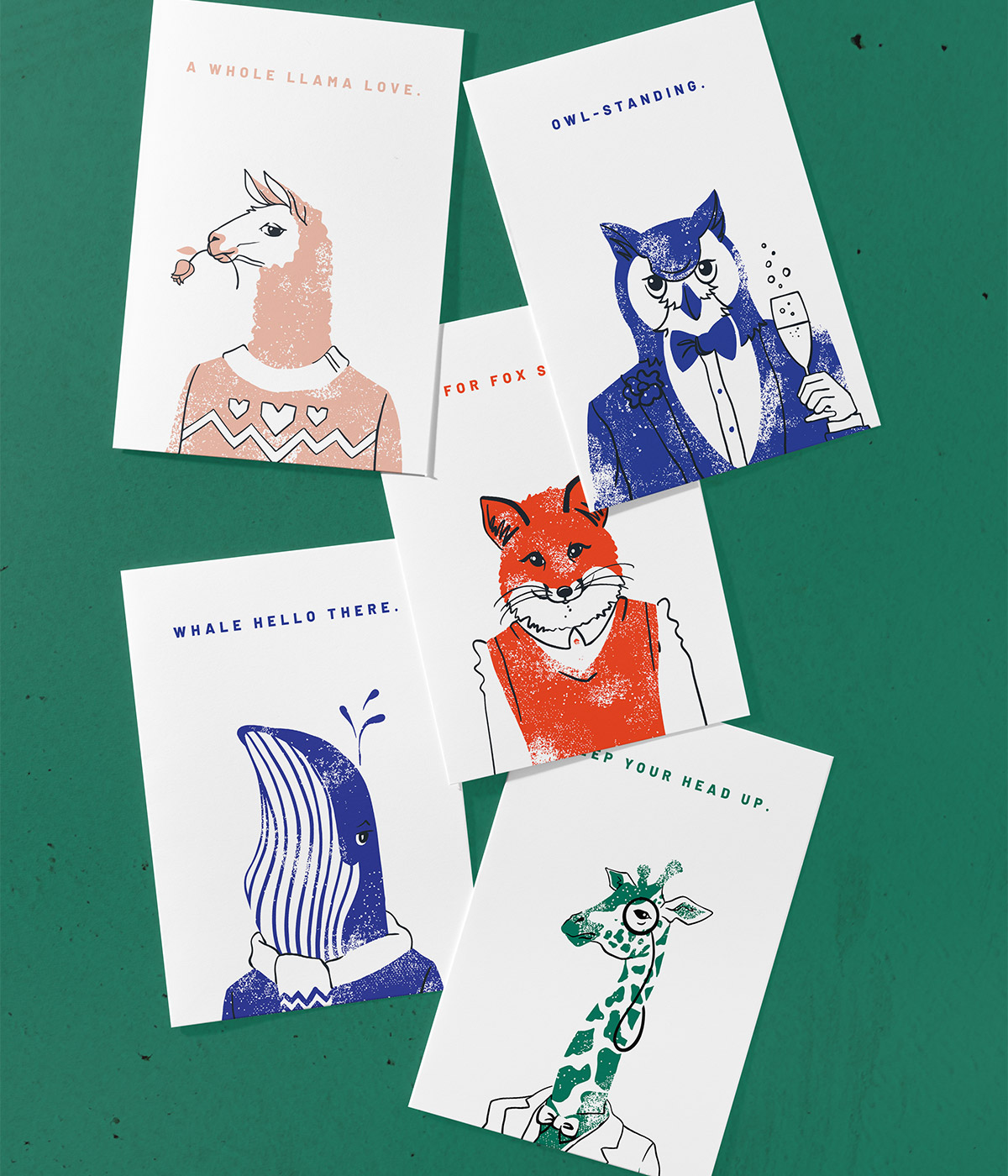 Assortment of dapper animal illustrations printed on cards laying on a dark green background