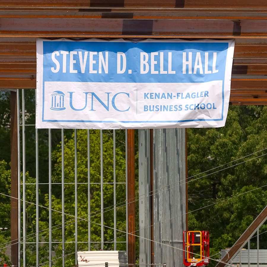 Steven D. Bell Hall UNC banner hanging from the (under construction) building