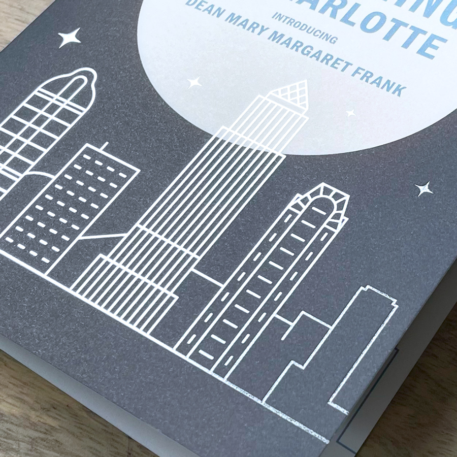 Close up of our white line drawing of the Charlotte skyline on the front of our Evening in Charlotte invitation